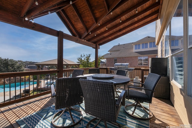 deck with a gazebo and a community pool