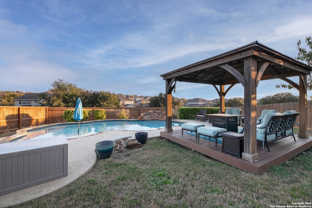 view of swimming pool with a gazebo, an outdoor hangout area, a lawn, and a wooden deck