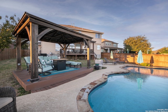 view of swimming pool with a gazebo, a patio area, and a wooden deck