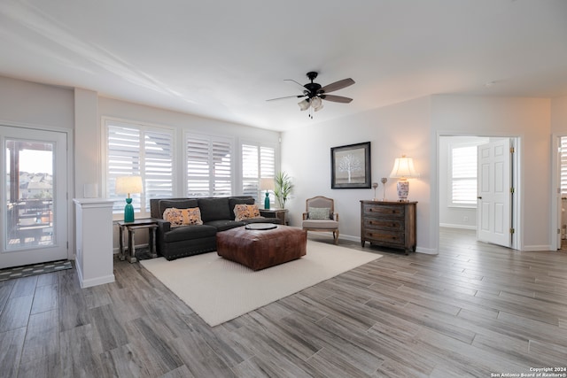 living room featuring light wood-type flooring, a wealth of natural light, and ceiling fan