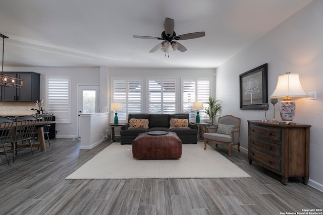 living room featuring dark hardwood / wood-style flooring, a wealth of natural light, and ceiling fan