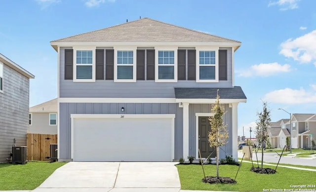 view of front facade featuring central AC, a front lawn, and a garage