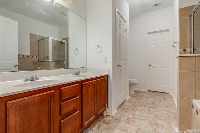 bathroom with walk in shower, vanity, lofted ceiling, and toilet