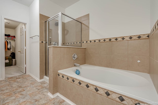 bathroom with tile patterned flooring and independent shower and bath