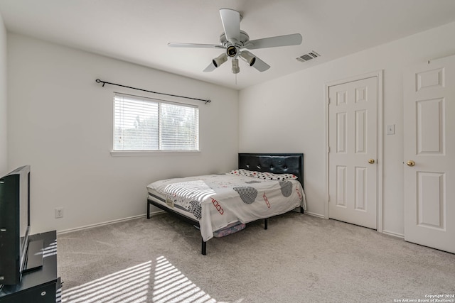 bedroom featuring ceiling fan and light carpet