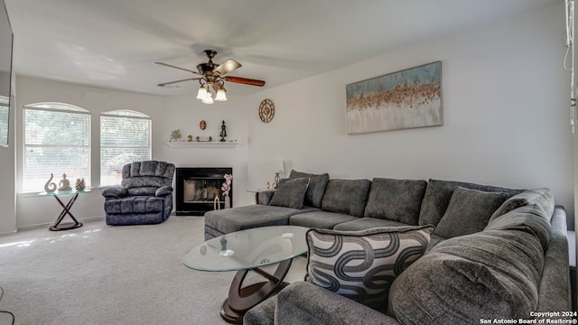 carpeted living room with ceiling fan