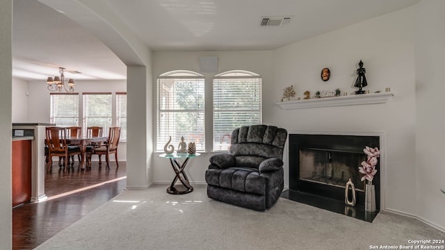 living area featuring dark hardwood / wood-style floors and a chandelier