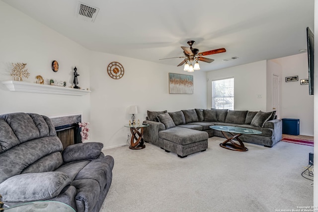 carpeted living room featuring ceiling fan