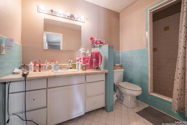 bathroom with tile patterned floors, a shower with curtain, vanity, tile walls, and toilet