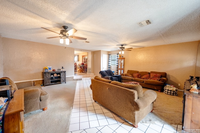 tiled living room featuring ceiling fan and a textured ceiling