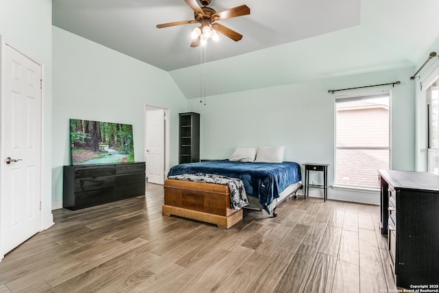 bedroom with light wood-type flooring, ceiling fan, and lofted ceiling