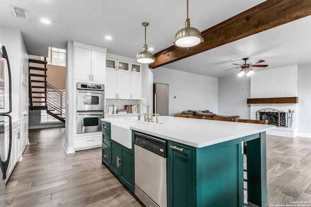 kitchen with visible vents, appliances with stainless steel finishes, light wood-type flooring, white cabinetry, and green cabinetry