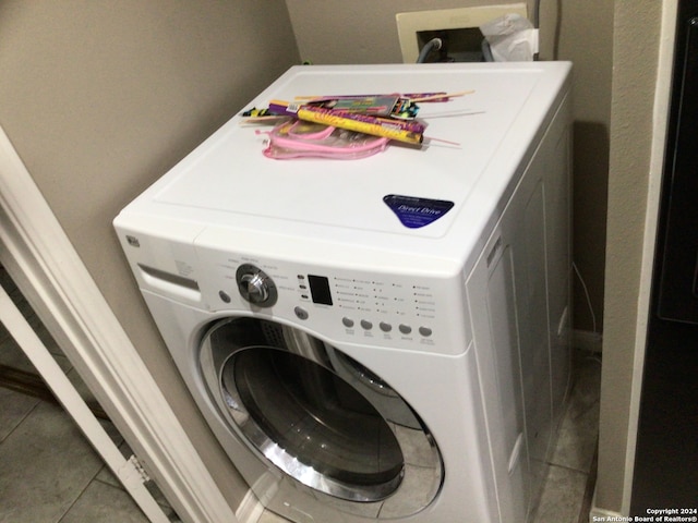 laundry room featuring tile patterned floors and washer / dryer