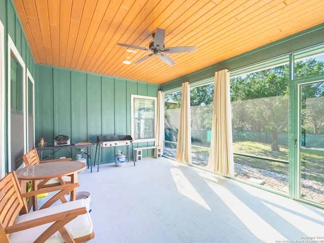 sunroom with ceiling fan and wood ceiling