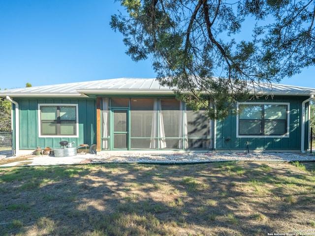 back of house featuring a sunroom