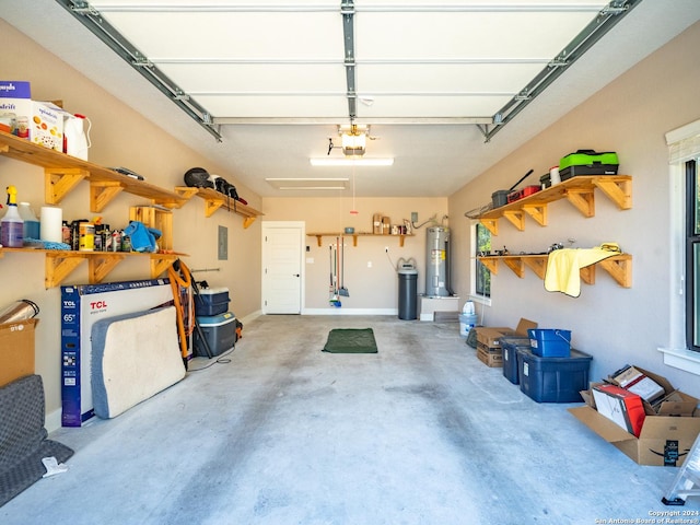 garage featuring electric panel, a garage door opener, and electric water heater