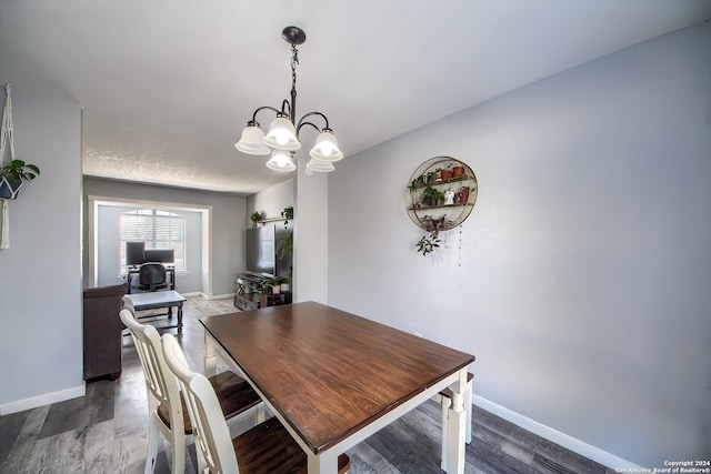 dining space featuring a chandelier and dark hardwood / wood-style flooring