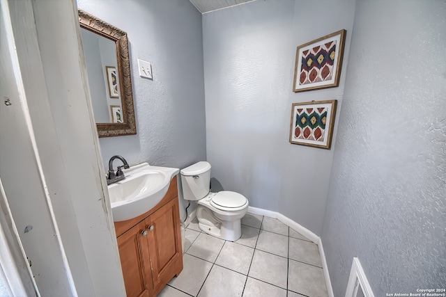 bathroom with tile patterned flooring, vanity, and toilet