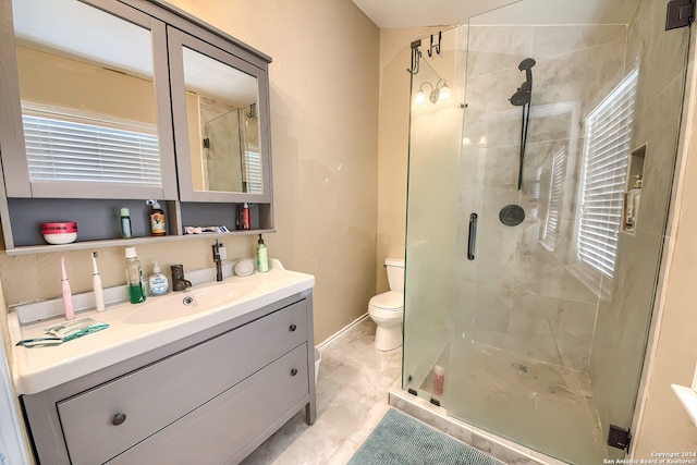 bathroom featuring toilet, an enclosed shower, and vanity