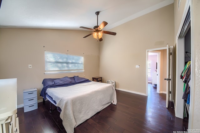 bedroom featuring ceiling fan, dark hardwood / wood-style flooring, and high vaulted ceiling