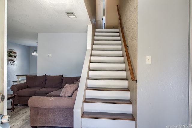 stairway with hardwood / wood-style floors