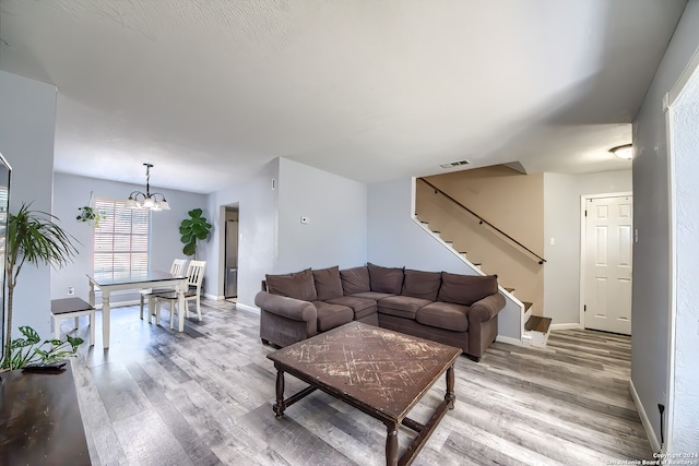 living room with a chandelier and hardwood / wood-style flooring