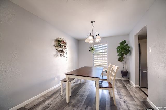 dining room featuring hardwood / wood-style flooring and an inviting chandelier