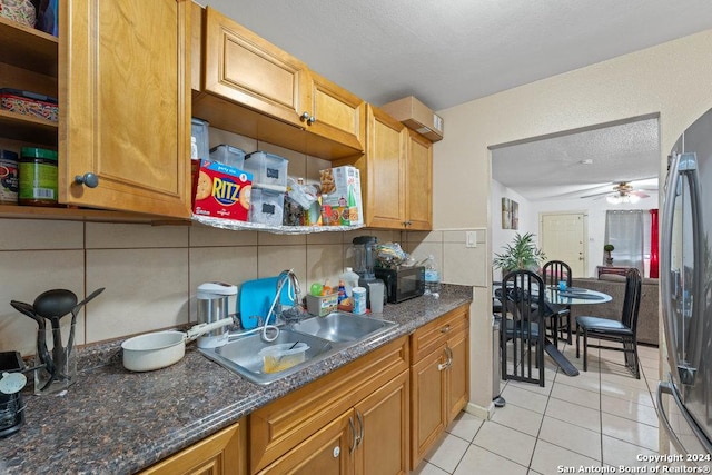 kitchen featuring black appliances, sink, decorative backsplash, ceiling fan, and light tile patterned floors