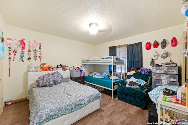 bedroom featuring hardwood / wood-style flooring and a textured ceiling