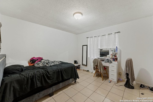 tiled bedroom with a textured ceiling