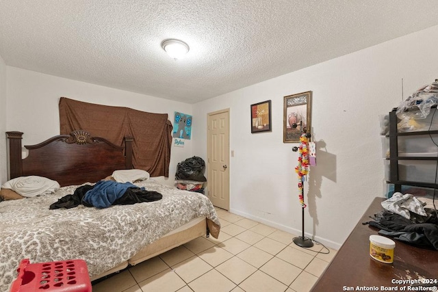 tiled bedroom featuring a textured ceiling