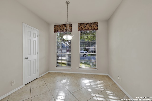 unfurnished dining area featuring light tile patterned flooring