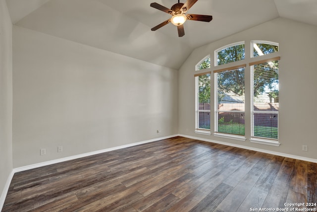 unfurnished room with dark hardwood / wood-style floors, ceiling fan, and vaulted ceiling