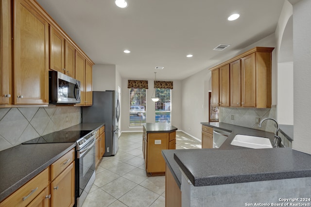 kitchen with a center island, sink, stainless steel appliances, backsplash, and pendant lighting