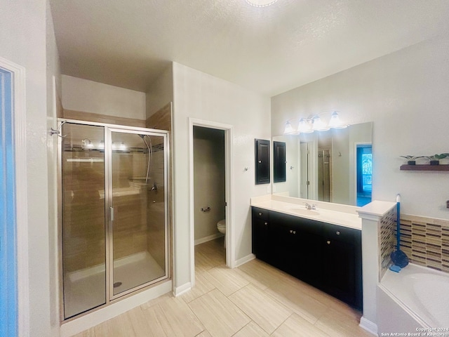 full bathroom featuring separate shower and tub, tile patterned floors, a textured ceiling, toilet, and vanity