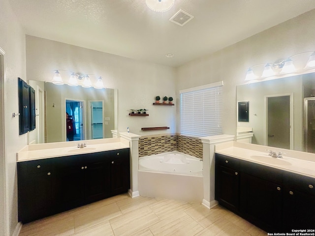 bathroom featuring tile patterned flooring, a textured ceiling, vanity, and plus walk in shower