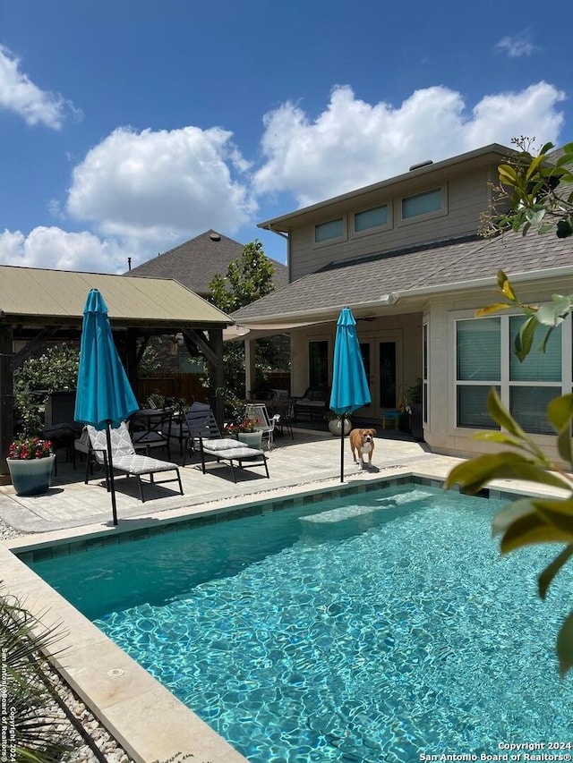 view of swimming pool with a gazebo and a patio area