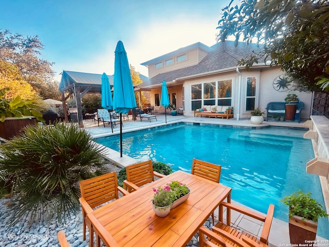 view of pool featuring an outdoor living space and a patio