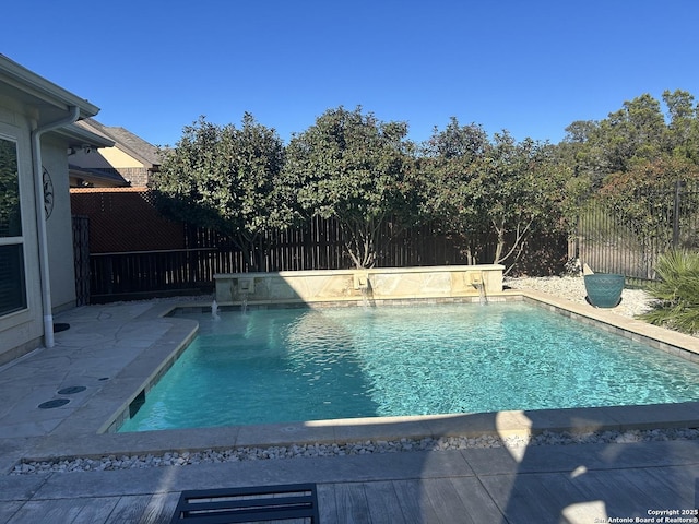 view of pool with pool water feature