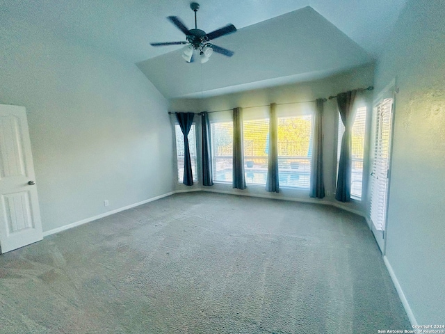 carpeted spare room with ceiling fan and lofted ceiling