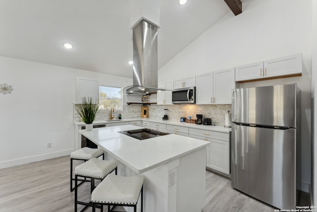 kitchen with a center island, white cabinets, light wood-type flooring, island range hood, and stainless steel appliances