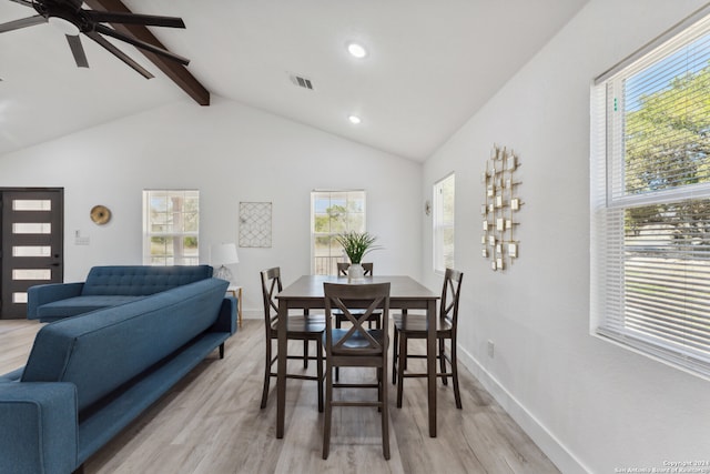 dining room featuring plenty of natural light, light hardwood / wood-style floors, ceiling fan, and lofted ceiling with beams