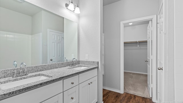 bathroom with vanity and wood-type flooring