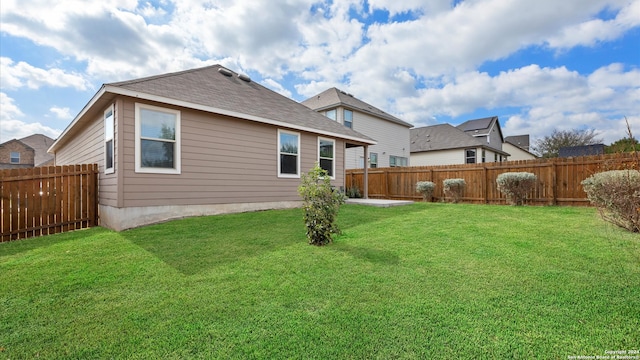 rear view of house featuring a yard