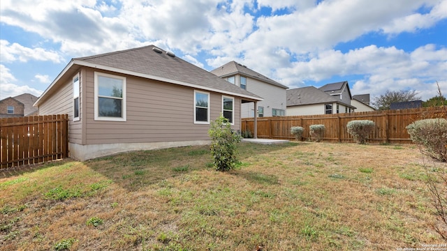 rear view of house featuring a lawn