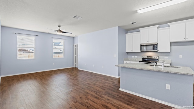 kitchen featuring white cabinetry, sink, stainless steel appliances, and dark hardwood / wood-style floors