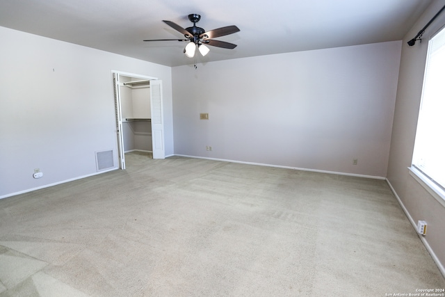 empty room featuring light carpet and ceiling fan