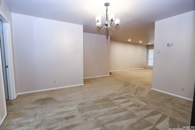 interior space with a notable chandelier and light carpet