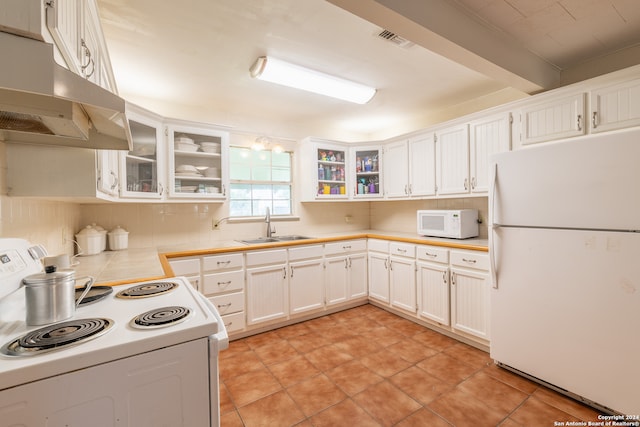 kitchen with decorative backsplash, white appliances, sink, beam ceiling, and white cabinets