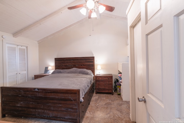 bedroom featuring lofted ceiling with beams, ceiling fan, and a closet